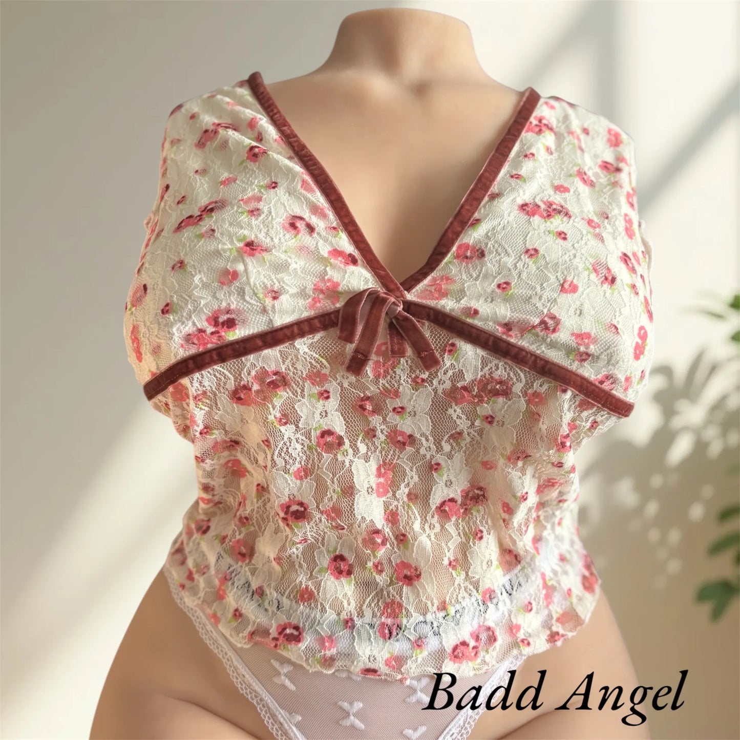 Badd Angel wearing a flowered top jennyfer